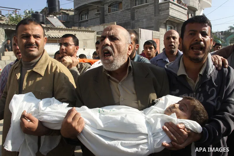 Palestinians carry the bodies of brothers Suhaib, 2-years-old, and Mohammed Hejazi, 4-years-old, during their funeral in the northern Gaza Strip area of Biet Lahia, on November 20, 2012. Four members of the Hejazi family...