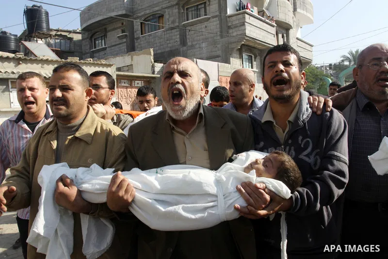 Palestinians carry the bodies of brothers Suhaib, 2-years-old, and Mohammed Hejazi, 4-years-old, during their funeral in the northern Gaza Strip area of Biet Lahia, on November 20, 2012. Four members of the Hejazi family...