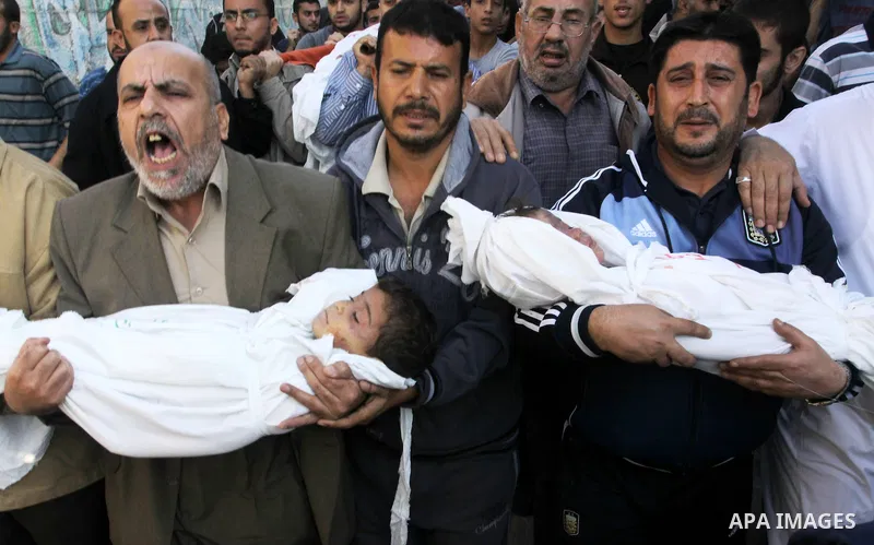 Palestinians carry the bodies of brothers Suhaib, 2-years-old, and Mohammed Hejazi, 4-years-old, during their funeral in the northern Gaza Strip area of Biet Lahia, on November 20, 2012. Four members of the Hejazi family...