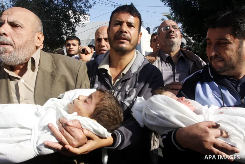 Palestinians carry the bodies of brothers Suhaib, 2-years-old, and Mohammed Hejazi, 4-years-old, during their funeral in the northern Gaza Strip area of Biet Lahia, on November 20, 2012. Four members of the Hejazi family...