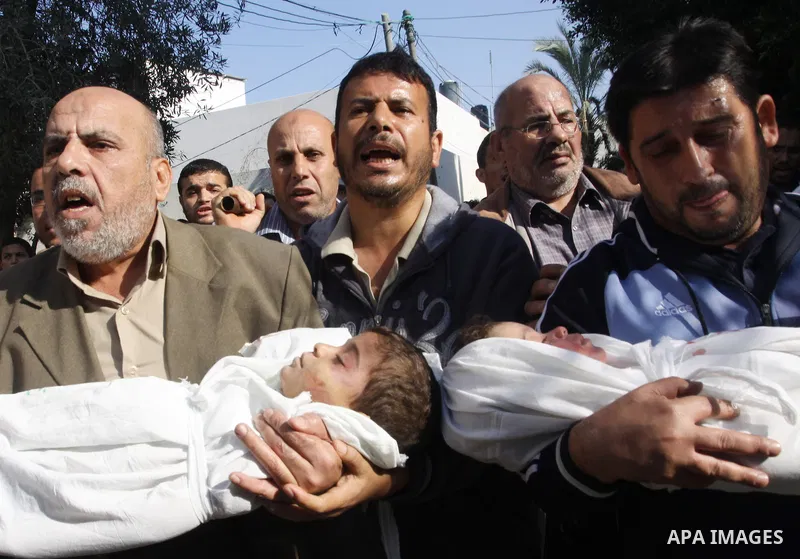 Palestinians carry the bodies of brothers Suhaib, 2-years-old, and Mohammed Hejazi, 4-years-old, during their funeral in the northern Gaza Strip area of Biet Lahia, on November 20, 2012. Four members of the Hejazi family...