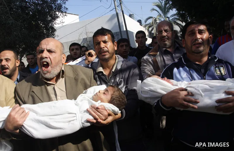 Palestinians carry the bodies of brothers Suhaib, 2-years-old, and Mohammed Hejazi, 4-years-old, during their funeral in the northern Gaza Strip area of Biet Lahia, on November 20, 2012. Four members of the Hejazi family...