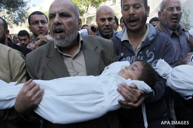 Palestinians carry the bodies of brothers Suhaib, 2-years-old, and Mohammed Hejazi, 4-years-old, during their funeral in the northern Gaza Strip area of Biet Lahia, on November 20, 2012. Four members of the Hejazi family...