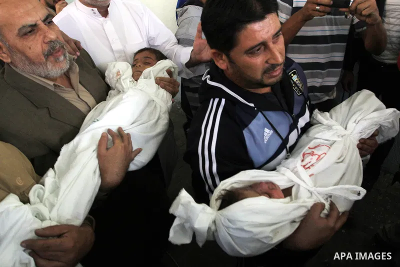 Palestinians carry the bodies of brothers Suhaib, 2-years-old, and Mohammed Hejazi, 4-years-old, during their funeral in the northern Gaza Strip area of Biet Lahia, on November 20, 2012. Four members of the Hejazi family...