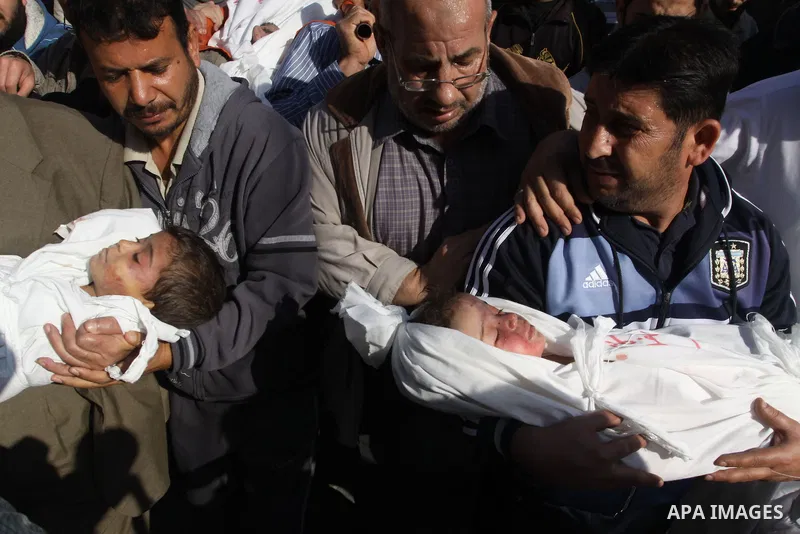 Palestinians carry the bodies of brothers Suhaib, 2-years-old, and Mohammed Hejazi, 4-years-old, during their funeral in the northern Gaza Strip area of Biet Lahia, on November 20, 2012. Four members of the Hejazi family...