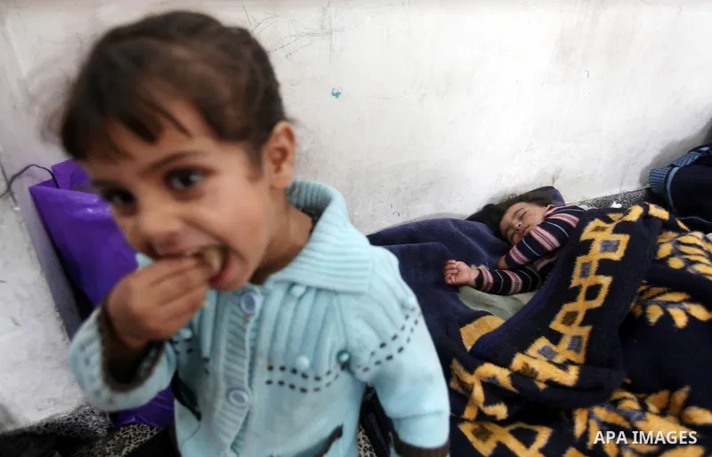 Displaced Palestinians from al-Atatra area, whose fled their house, gather in their temporary residence, at a United Nations-run school in Gaza City, on November 20, 2012. Israeli leaders discussed an Egyptian plan for a...