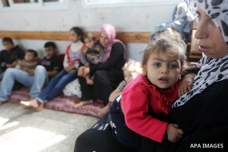Displaced Palestinians from al-Atatra area, whose fled their house, gather in their temporary residence, at a United Nations-run school in Gaza City, on November 20, 2012. Israeli leaders discussed an Egyptian plan for a...