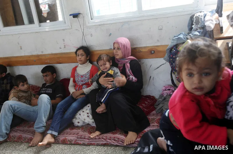 Displaced Palestinians from al-Atatra area, whose fled their house, gather in their temporary residence, at a United Nations-run school in Gaza City, on November 20, 2012. Israeli leaders discussed an Egyptian plan for a...