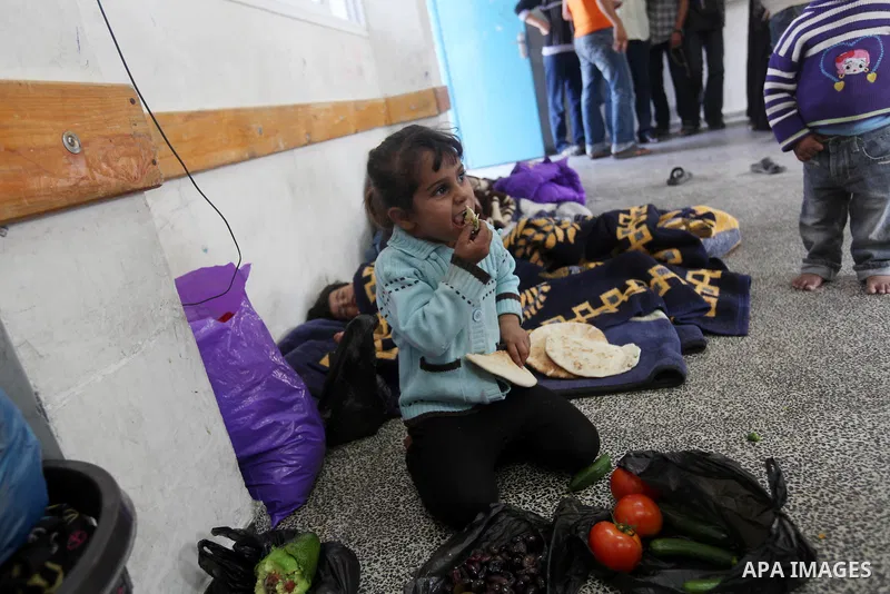 Displaced Palestinians from al-Atatra area, whose fled their house, gather in their temporary residence, at a United Nations-run school in Gaza City, on November 20, 2012. Israeli leaders discussed an Egyptian plan for a...