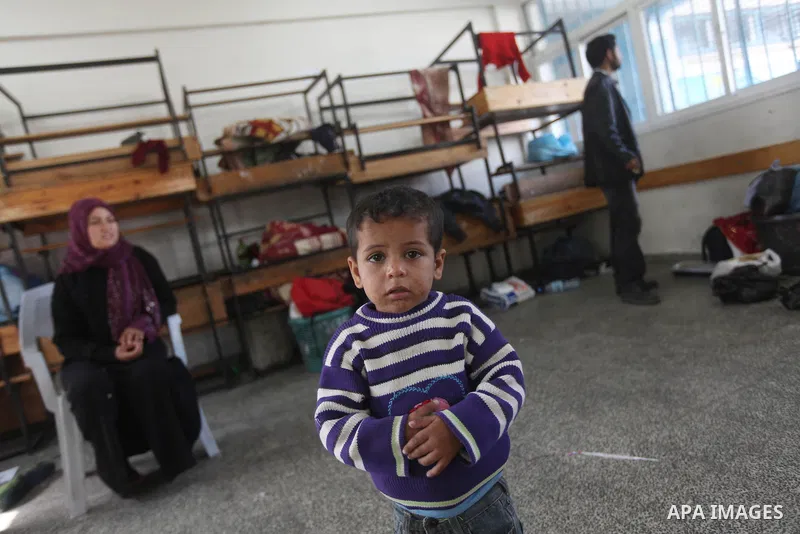 Displaced Palestinians from al-Atatra area, whose fled their house, gather in their temporary residence, at a United Nations-run school in Gaza City, on November 20, 2012. Israeli leaders discussed an Egyptian plan for a...