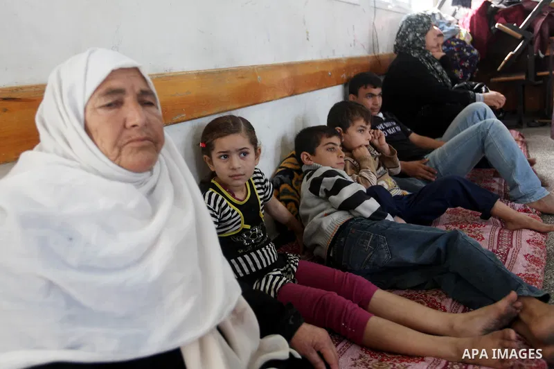 Displaced Palestinians from al-Atatra area, whose fled their house, gather in their temporary residence, at a United Nations-run school in Gaza City, on November 20, 2012. Israeli leaders discussed an Egyptian plan for a...