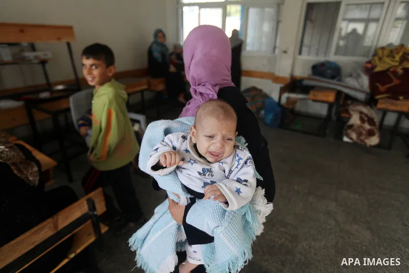 Displaced Palestinians from al-Atatra area, whose fled their house, gather in their temporary residence, at a United Nations-run school in Gaza City, on November 20, 2012. Israeli leaders discussed an Egyptian plan for a...