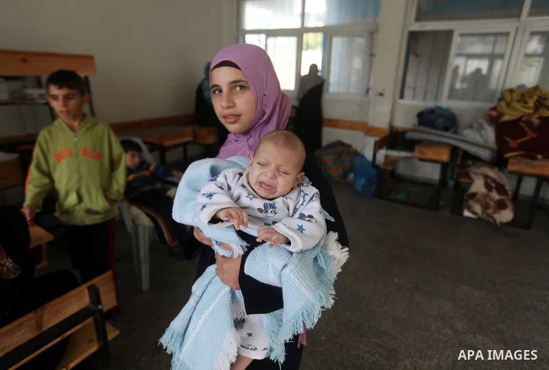 Displaced Palestinians from al-Atatra area, whose fled their house, gather in their temporary residence, at a United Nations-run school in Gaza City, on November 20, 2012. Israeli leaders discussed an Egyptian plan for a...