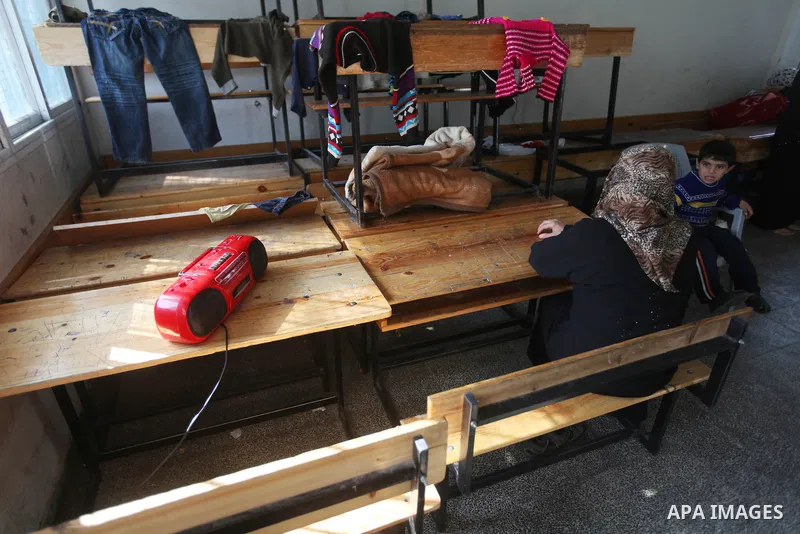 Displaced Palestinians from al-Atatra area, whose fled their house, gather in their temporary residence, at a United Nations-run school in Gaza City, on November 20, 2012. Israeli leaders discussed an Egyptian plan for a...