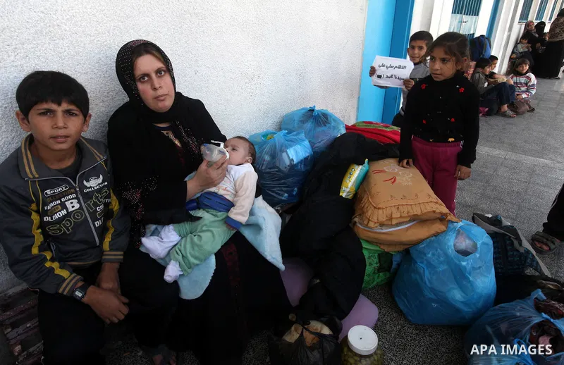 Displaced Palestinians from al-Atatra area, whose fled their house, gather in their temporary residence, at a United Nations-run school in Gaza City, on November 20, 2012. Israeli leaders discussed an Egyptian plan for a...