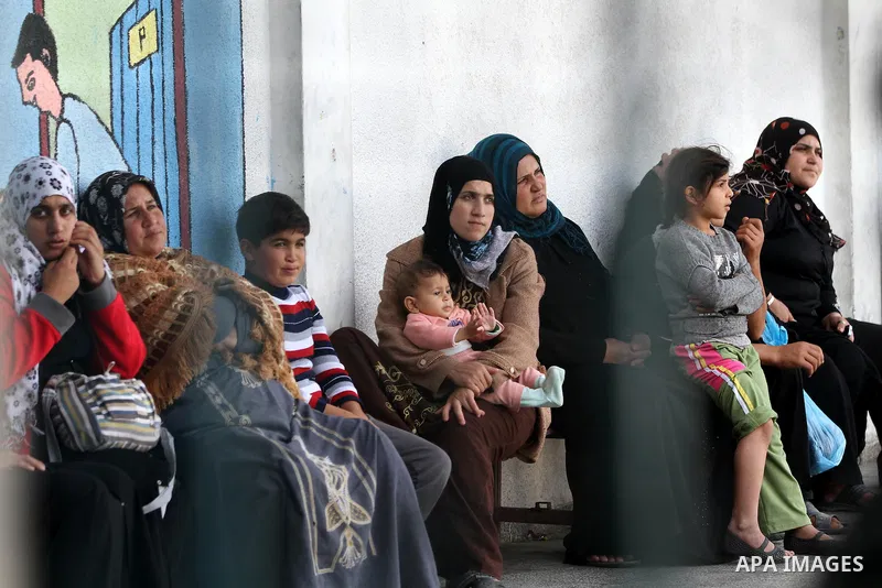 Displaced Palestinians from al-Atatra area, whose fled their house, gather in their temporary residence, at a United Nations-run school in Gaza City, on November 20, 2012. Israeli leaders discussed an Egyptian plan for a...