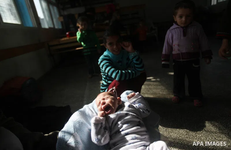 Displaced Palestinians from al-Atatra area, whose fled their house, gather in their temporary residence, at a United Nations-run school in Gaza City, on November 20, 2012. Israeli leaders discussed an Egyptian plan for a...