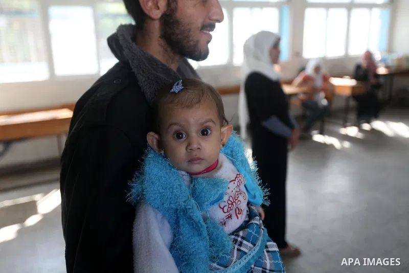Displaced Palestinians from al-Atatra area, whose fled their house, gather in their temporary residence, at a United Nations-run school in Gaza City, on November 20, 2012. Israeli leaders discussed an Egyptian plan for a...