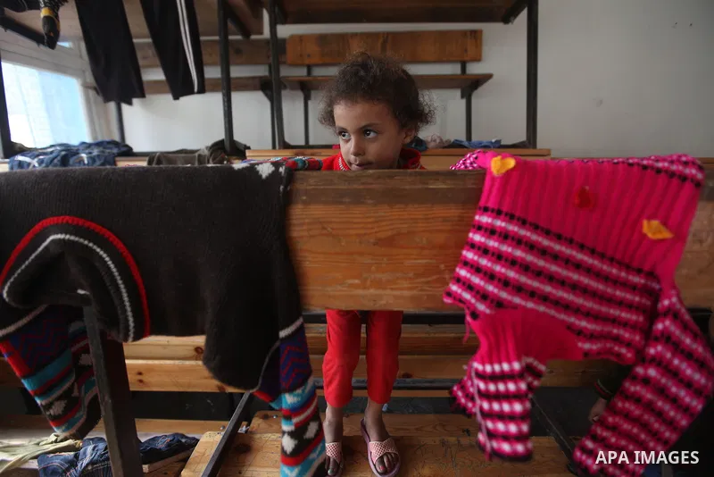 A Displaced Palestinian girl from al-Atatra area, who feld her house play in a classroom, her temporary residence, at a United Nations-run school in Gaza City, on November 20, 2012. Israeli leaders discussed an Egyptian...