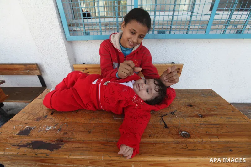 Displaced Palestinian children from the al-Attar area, whose fled their house, play in a classroom, their temporary residence, at a United Nations-run school in Gaza City, on November 20, 2012. Israeli leaders discussed...