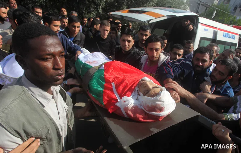 Palestinians carry the body of Osama Shehada, 17, during his funeral in the Nuseirat Refugee Camp, central Gaza Strip, Tuesday, Nov. 20, 2012. Shehada was killed in an Israeli air strike on Monday while walking with his...