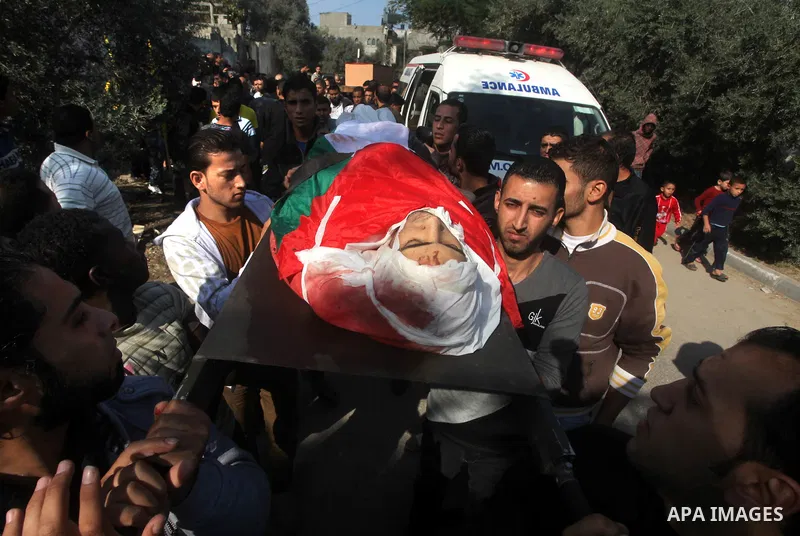 Palestinians carry the body of Osama Shehada, 17, during his funeral in the Nuseirat Refugee Camp, central Gaza Strip, Tuesday, Nov. 20, 2012. Shehada was killed in an Israeli air strike on Monday while walking with his...