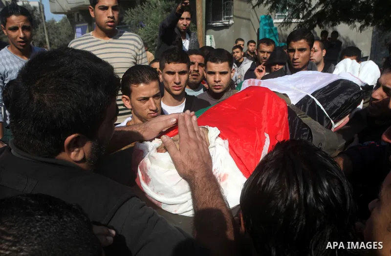 Palestinians carry the body of Osama Shehada, 17, during his funeral in the Nuseirat Refugee Camp, central Gaza Strip, Tuesday, Nov. 20, 2012. Shehada was killed in an Israeli air strike on Monday while walking with his...