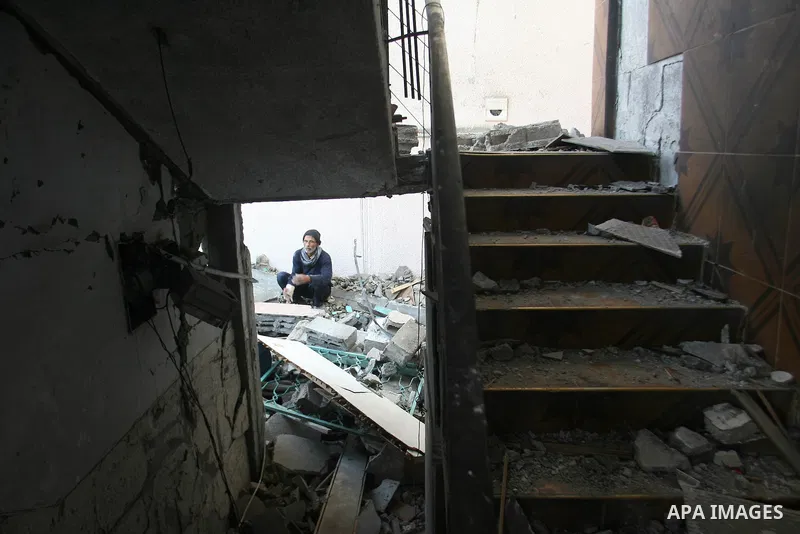 Palestinians inspect damaged buildings following Israeli air strikes on the southern Gaza Strip town of Rafah on November 20, 2012. The Israeli military said it attacked about 100 targets in the coastal strip during the...