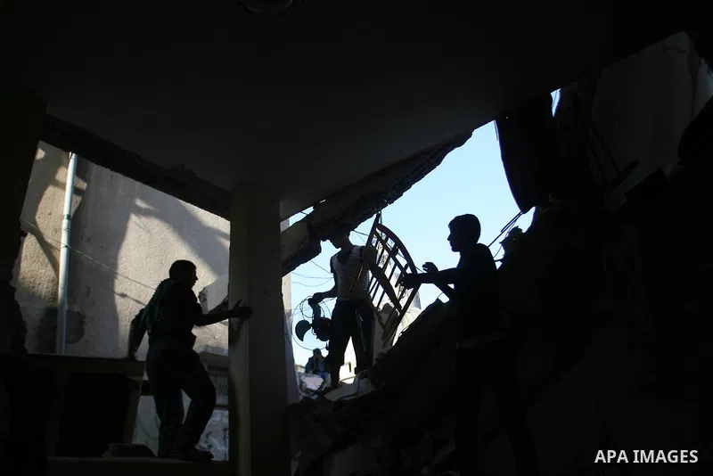 Palestinians inspect damaged buildings following Israeli air strikes on the southern Gaza Strip town of Rafah on November 20, 2012. The Israeli military said it attacked about 100 targets in the coastal strip during the...