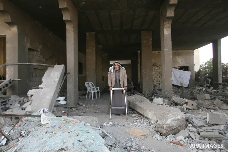 Palestinians inspect damaged buildings following Israeli air strikes on the southern Gaza Strip town of Rafah on November 20, 2012. The Israeli military said it attacked about 100 targets in the coastal strip during the...