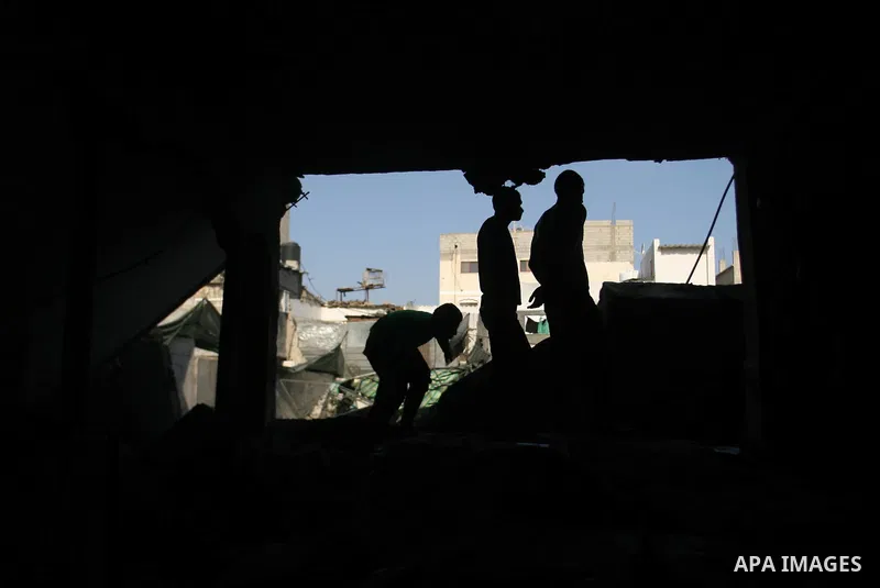 Palestinians inspect damaged buildings following Israeli air strikes on the southern Gaza Strip town of Rafah on November 20, 2012. The Israeli military said it attacked about 100 targets in the coastal strip during the...