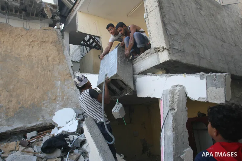 Palestinians inspect damaged buildings following Israeli air strikes on the southern Gaza Strip town of Rafah on November 20, 2012. The Israeli military said it attacked about 100 targets in the coastal strip during the...