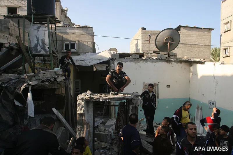 Palestinians inspect damaged buildings following Israeli air strikes on the southern Gaza Strip town of Rafah on November 20, 2012. The Israeli military said it attacked about 100 targets in the coastal strip during the...