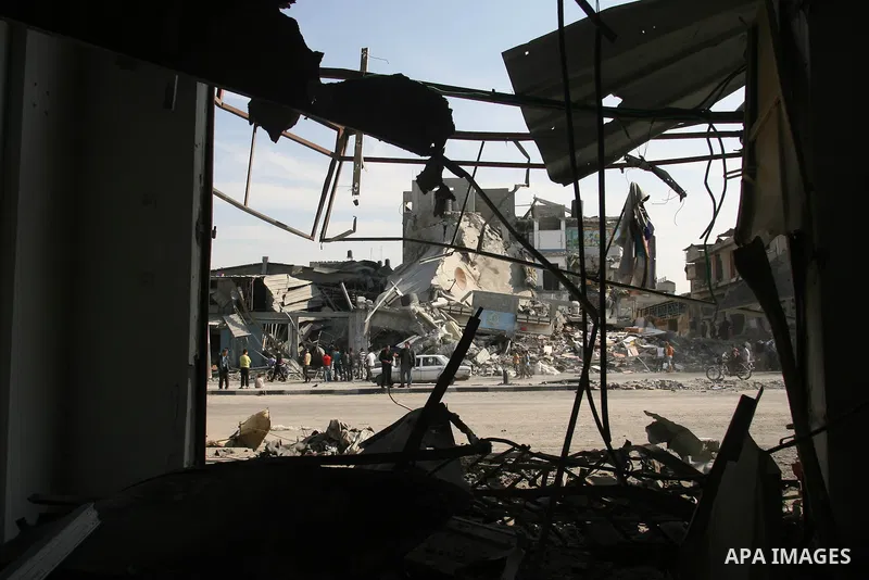 Palestinians inspect damaged buildings following Israeli air strikes on the southern Gaza Strip town of Rafah on November 20, 2012. The Israeli military said it attacked about 100 targets in the coastal strip during the...