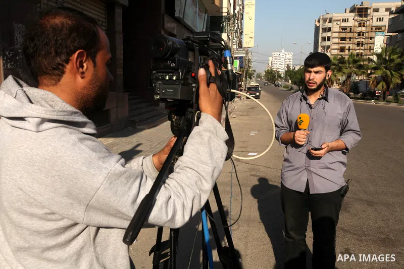 Palestinian members of media record a report in Gaza city, on November 20, 2012. Two Palestinian journalists were killed in an Israeli airstrike on Gaza City Tuesday evening, after media buildings were hit by Israeli war...