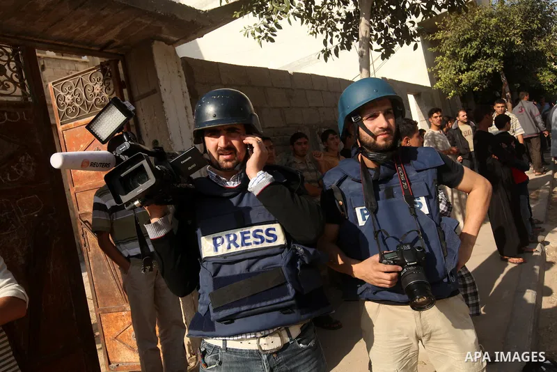 Palestinian members of media stand waiting in Gaza city, on November 20, 2012. Two Palestinian journalists were killed in an Israeli airstrike on Gaza City Tuesday evening, after media buildings were hit by Israeli warpl...