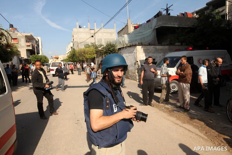 A Palestinian photographer takes pictures in Gaza city, on November 20, 2012. Two Palestinian journalists were killed in an Israeli airstrike on Gaza City Tuesday evening, after media buildings were hit by Israeli warpla...