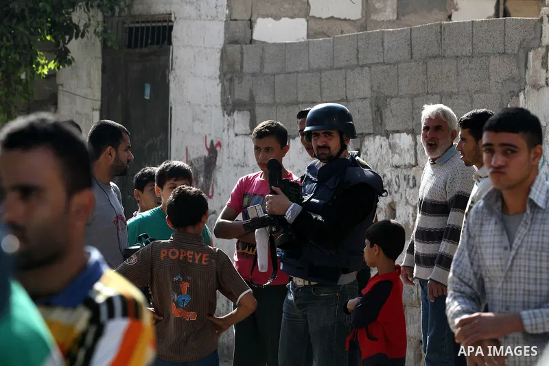 A Palestinian cameraman stands waiting in a street in Gaza city, on November 20, 2012. Two Palestinian journalists were killed in an Israeli airstrike on Gaza City Tuesday evening, after media buildings were hit by Israe...