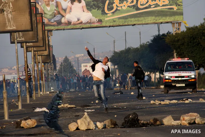 Palestinian protesters throw stones at Israeli soldiers during clashes in the West Bank city of Nablus, on November 20, 2012. The West Bank has witnessed almost daily demonstrations in support of Gaza Palestinians who ha...