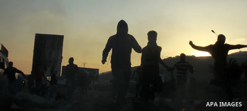 Palestinian stone throwers run for cover during clashes with Israeli security forces in the West Bank city of Nablus, on November 20, 2012. The West Bank has witnessed almost daily demonstrations in support of Gaza Pales...
