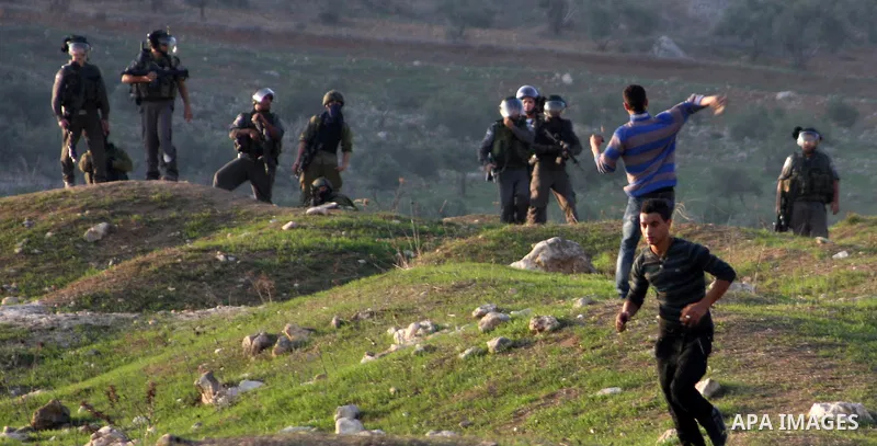 Palestinian protesters throw stones at Israeli soldiers during clashes in the West Bank city of Nablus, on November 20, 2012. The West Bank has witnessed almost daily demonstrations in support of Gaza Palestinians who ha...