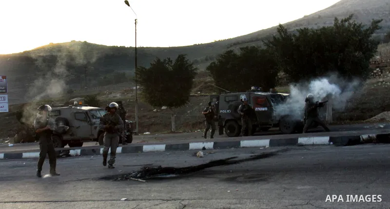 Israeli border policemen fire tear gas at Palestinian protesters during clashes in the West Bank city of Nablus, on November 20, 2012. The West Bank has witnessed almost daily demonstrations in support of Gaza Palestinia...