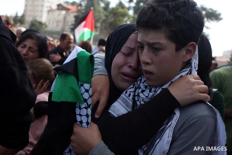 Relatives grieve Rushdi Tamimi who died of injuries sustained during clashes Saturday with Israeli security, during his funeral in the West Bank city of Ramallah, Tuesday, Nov 20, 2012. Tamimi was wounded during a protes...