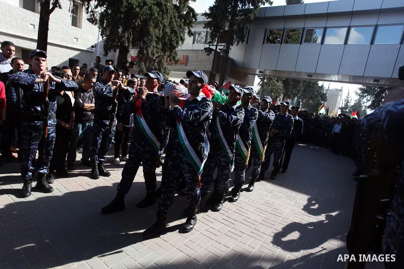 Palestinian policemen carry the body of their comrade Rushdi Tamimi, 31, during his funeral procession in the West Bank city of Ramallah November 20, 2012. amimi was wounded during a protest against Israel's operation in...