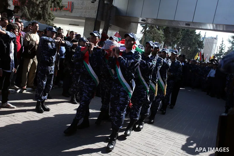 Palestinian policemen carry the body of their comrade Rushdi Tamimi, 31, during his funeral procession in the West Bank city of Ramallah November 20, 2012. amimi was wounded during a protest against Israel's operation in...