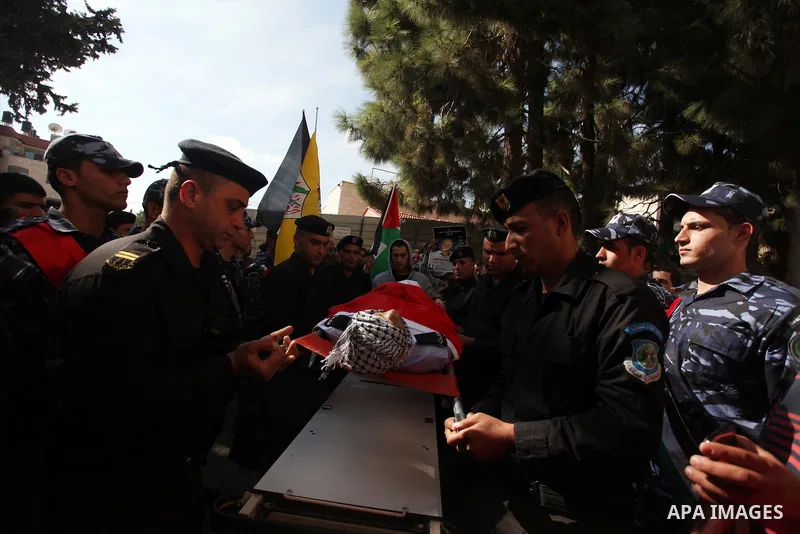 Palestinian policemen carry the body of their comrade Rushdi Tamimi, 31, during his funeral procession in the West Bank city of Ramallah November 20, 2012. amimi was wounded during a protest against Israel's operation in...