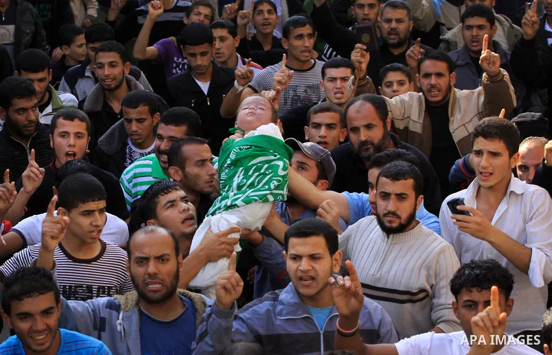 Palestinians carry the bodies of brothers Suhaib, 2-years-old, and Mohammed Hejazi, 4-years-old, during their funeral in the northern Gaza Strip area of Biet Lahia, on November 20, 2012. Four members of the Hejazi family...