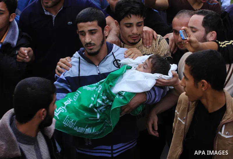 Palestinians carry the bodies of brothers Suhaib, 2-years-old, and Mohammed Hejazi, 4-years-old, during their funeral in the northern Gaza Strip area of Biet Lahia, on November 20, 2012. Four members of the Hejazi family...