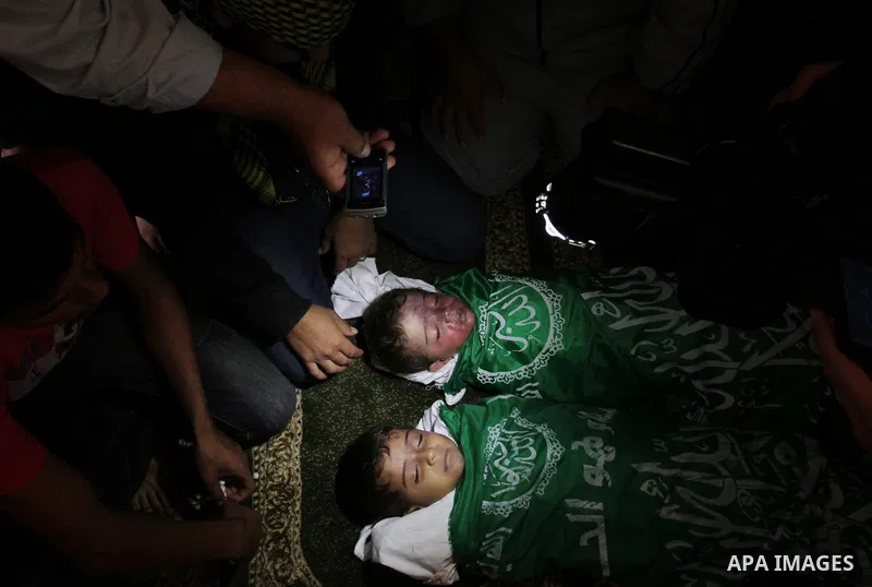 Relatives of Foud Hijazi, 45, grieves over the bodies of her son and grandsons Suhaib, 2, and Mohammed, 4, killed in an Israeli strike, during their funeral at a mosque in the Jebaliya refugee camp, in Gaza Strip, Tuesda...