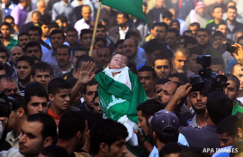 Palestinians carry the bodies of brothers Suhaib, 2-years-old, and Mohammed Hejazi, 4-years-old, during their funeral in the northern Gaza Strip area of Biet Lahia, on November 20, 2012. Four members of the Hejazi family...